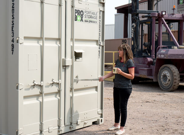 A Woman Inspecting the Pro Box Storage Container in AZ, CO, OK, and TX